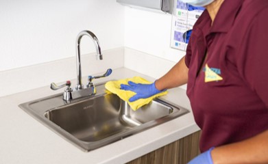 ServiceMaster Clean Technician cleaning a sink