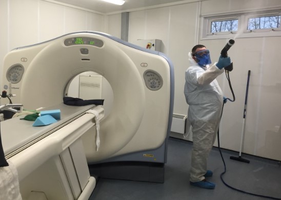 Man Using Mist to Disinfect Room