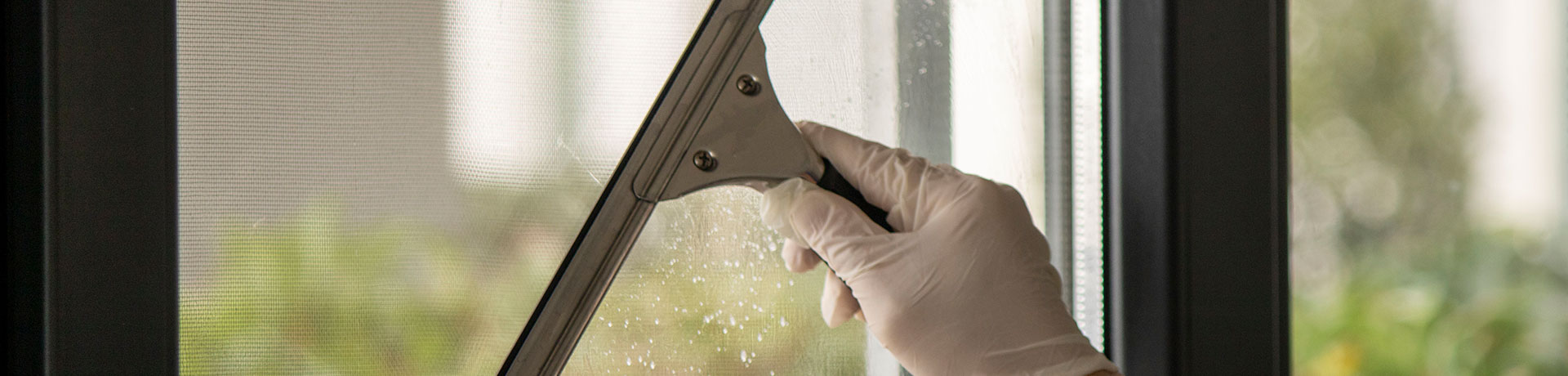 ServiceMaster Clean professional performing an exterior office window cleaning service