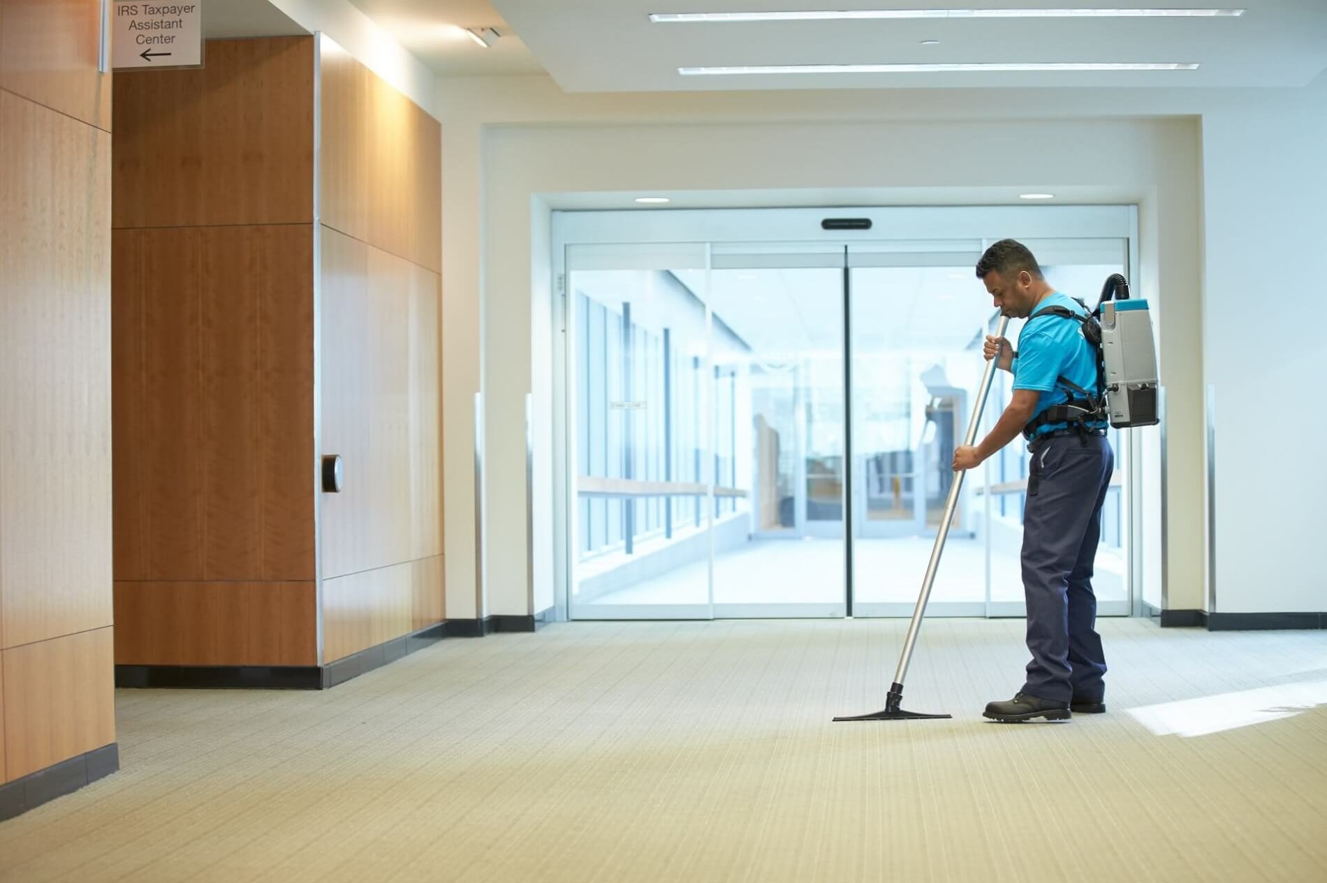 servicemaster clean technician cleaning floors in an office