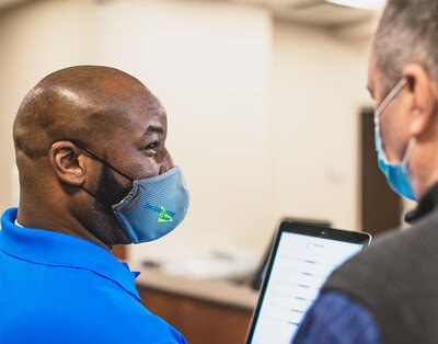 ServiceMaster Clean franchisee smiling while speaking with a customer