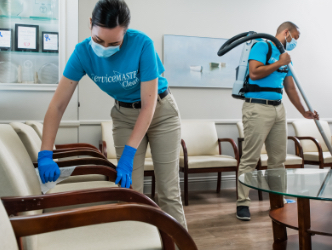 Two ServiceMaster Clean janitors cleaning a medical office waiting room
