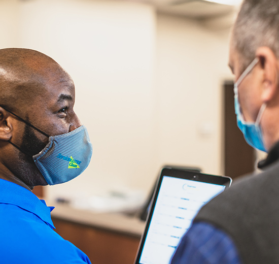 man typing on tablet