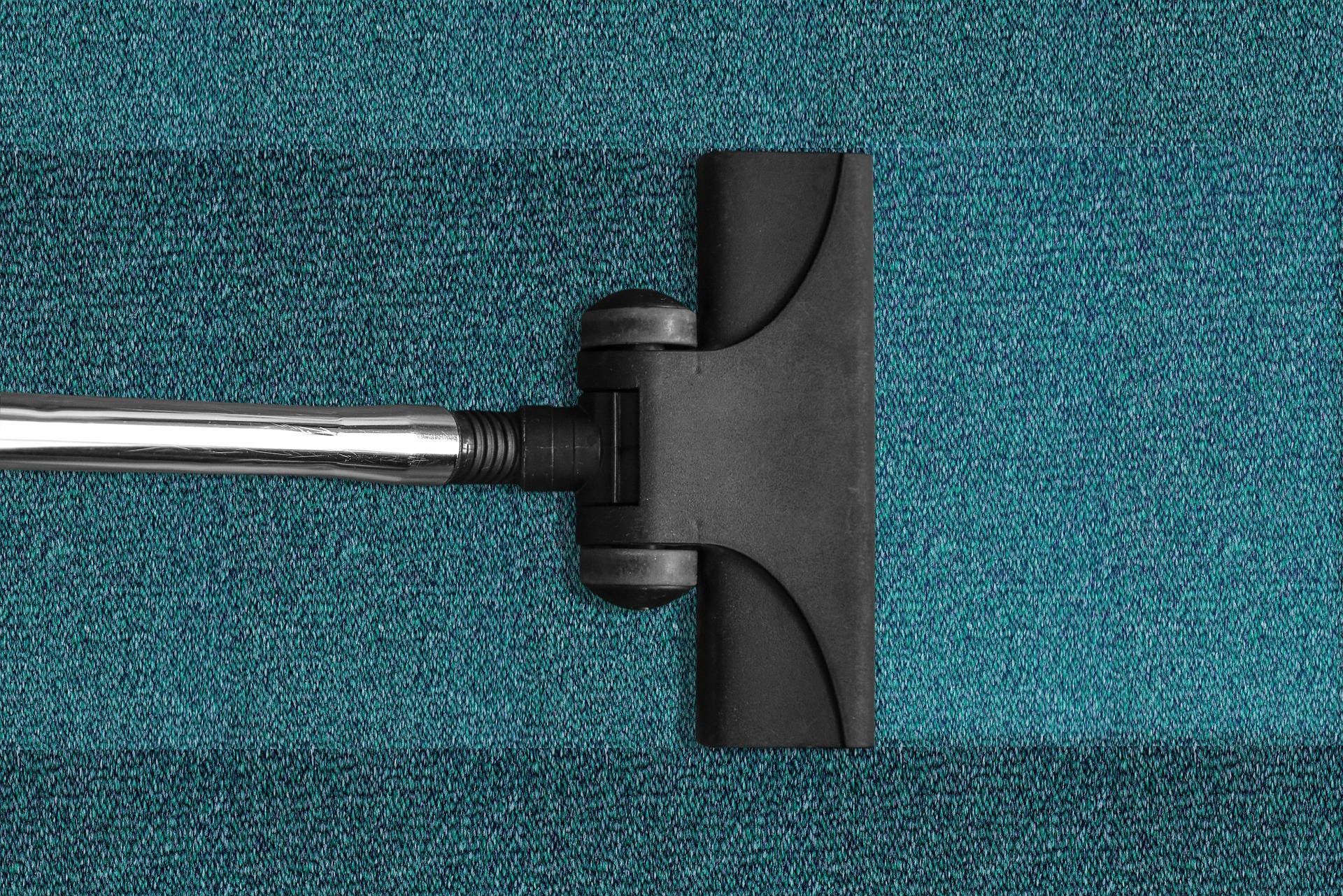 Commercial janitorial cleaning with a vacuum cleaner on carpet