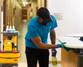 ServiceMaster Clean employee cleaning an office desk