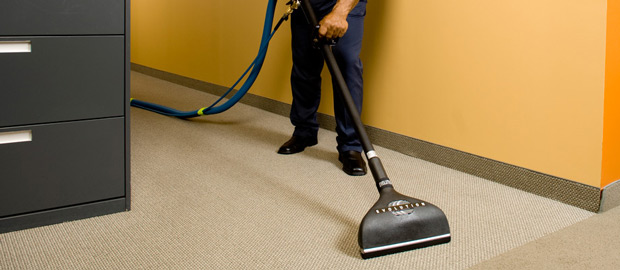 Person with a carpet cleaner