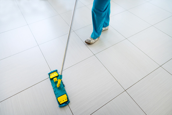 servicemaster clean technician mopping floor in building