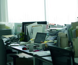office desks cluttered with office supplies