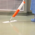 Healthcare worker cleaning floor