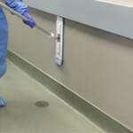 Healthcare worker cleaning wall