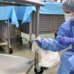 Healthcare worker cleaning table legs