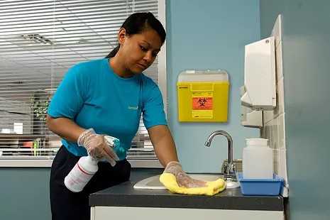 A ServiceMaster technician sanitizing a medical facility during janitorial cleaning services 