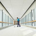 man cleaning hallway