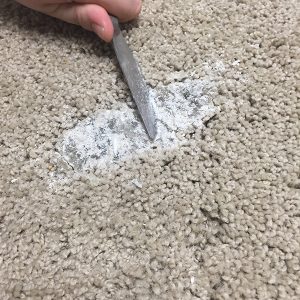 scraping-candle-wax-off-carpet-with-butter-knife