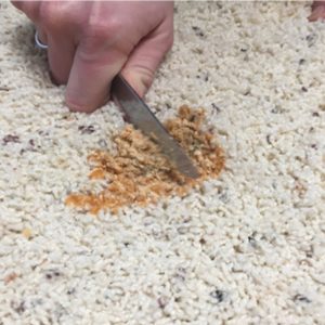 scraping-dry-candle-wax-out-of-carpet-with-dull-knife