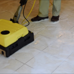 man cleaning tile floor