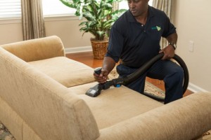 Man cleaning a couch