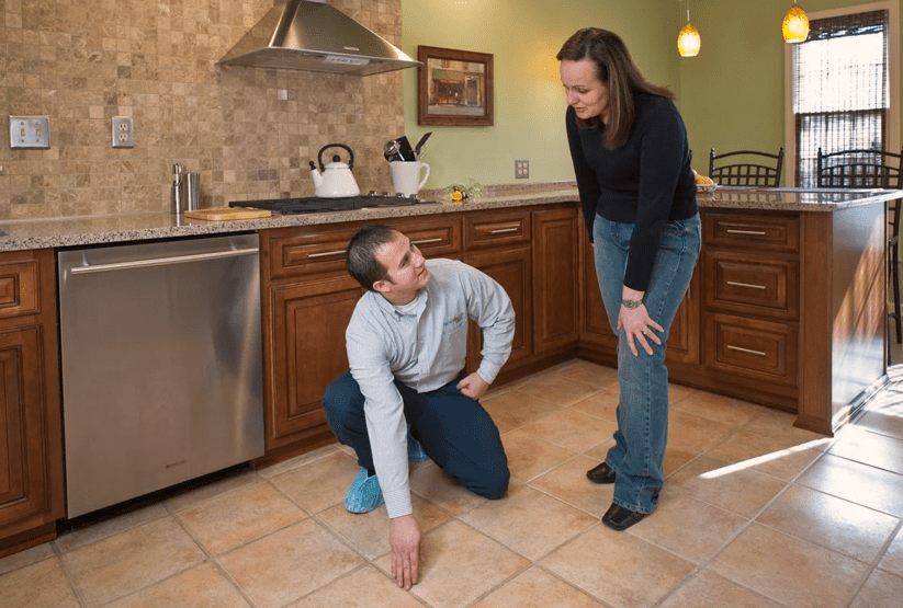 Man and women looking at a tiled floor