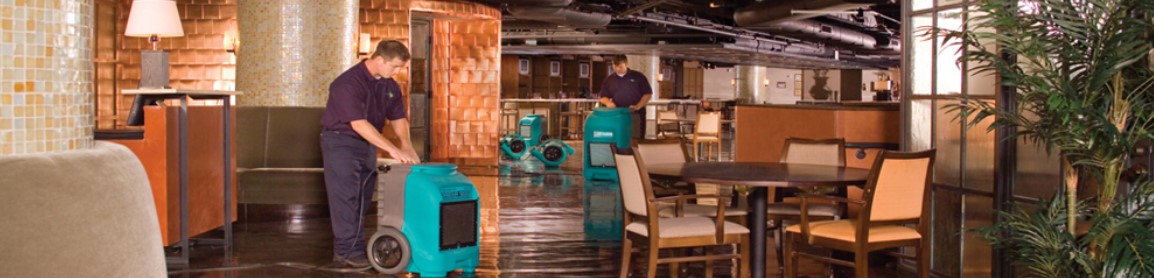 two tech using machines to clean up water damage