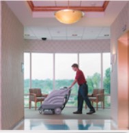 man using machine to clean tile floors
